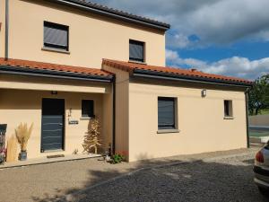 a house with a car parked in front of it at Le QG chez Flo et David in Saint-Julien-Molin-Molette