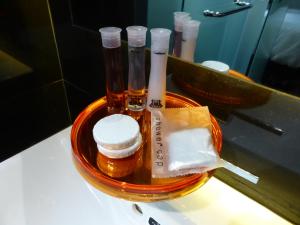 a bowl with bottles of honey on a counter at Melange Boutique Hotel Bukit Bintang in Kuala Lumpur