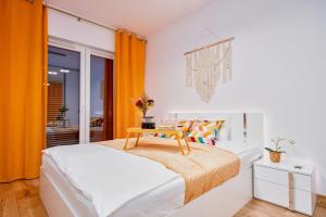 a bedroom with a bed with a table on it at Poznań Grunwald - Parking & Terrace - by Rentujemy in Poznań