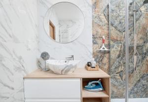 a bathroom with a sink and a mirror at Poznań Grunwald - Parking & Terrace - by Rentujemy in Poznań +13 photos