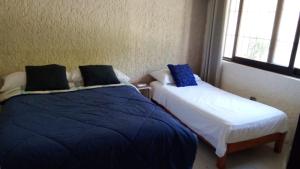 Letto o letti in una camera di Naranjo Hostel