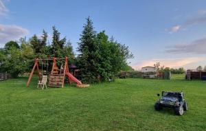an atv parked in a yard with a playground at 1 Bedroom Stunning Home In Rekowo in Rekowo