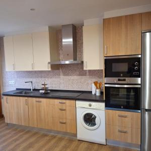 a kitchen with a sink and a dishwasher at Casa Buenavista Vut in Revenga