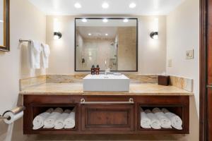 a bathroom with a sink and a large mirror at The Lodge at Jackson Hole in Jackson