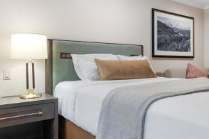 a hotel room with two beds and a lamp at The Lodge at Jackson Hole in Jackson