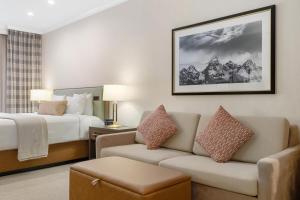 a hotel room with a bed and a couch at The Lodge at Jackson Hole in Jackson