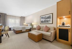 a large hotel room with a bed and a couch at The Lodge at Jackson Hole in Jackson