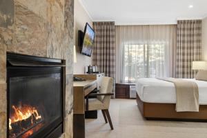 a hotel room with a fireplace and a bed at The Lodge at Jackson Hole in Jackson
