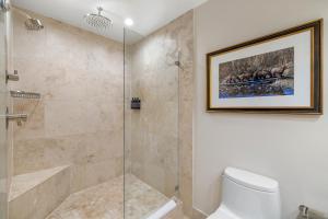 a bathroom with a shower stall and a toilet at The Lodge at Jackson Hole in Jackson