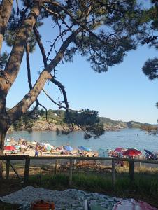 a group of people on a beach near the water at Apartamento Ons in Bueu