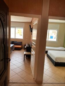 a bedroom with a bed and a living room at Europa mirlef t aventur Guest House in Mirleft