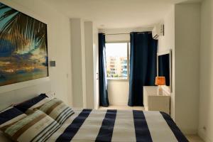 a bedroom with a bed and a window at Altea Sound of the Sea in Altea