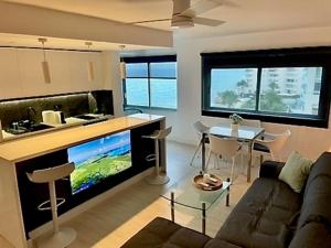a living room with a couch and a tv and a table at Altea Sound of the Sea in Altea