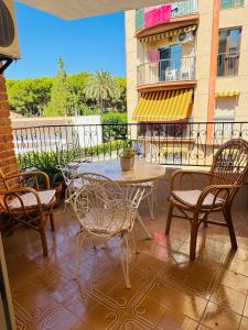 a patio with a table and chairs on a balcony at Holiday Vintage Apartment in San Pedro del Pinatar