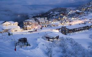 una piccola città nella neve di notte di Nolyski a Mount Hotham