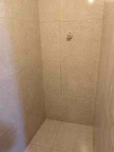 a bathroom with a shower with a tile floor at la casa de los amigos in Arequipa +24 photos
