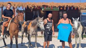 a group of men standing next to a group of horses at Camping Lekdushi - Shehu in Tepelenë +29 photos