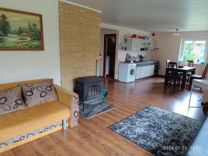 a living room with a couch and a stove at Nr.42 in Palanga