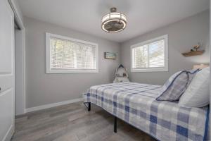 a bedroom with a bed and two windows at Sunset Villa B6 in Bridgman