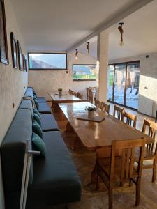 a living room with a long couch and a table at Къща Принцеса Анастасия in Chiprovtsi