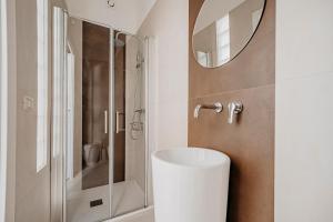 a bathroom with a sink and a shower with a mirror at New Design Ortigia in Siracusa +45 photos