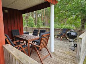 a deck with a grill and a table and chairs at Nya Matsas in Noarootsi