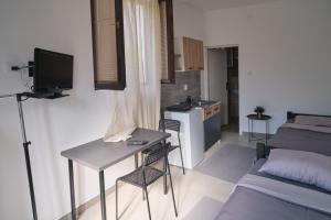 a small living room with a bed and a table at Studio Melem 3 in Soko Banja