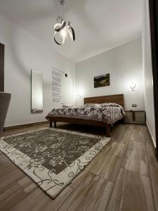 a bedroom with a bed and a rug at B&B Paola City in Paola