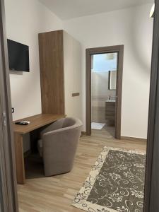 a room with a desk and a chair next to a desk at B&B Paola City in Paola +18 photos