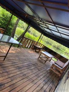 a wooden deck with a bench and a picnic table at Chata Párničkovo in Párnica +9 photos