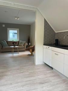 a living room with a couch and a table at 2 etasje leilighet med 2 soverom in Harstad