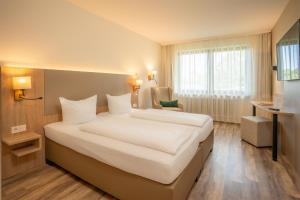 Ένα ή περισσότερα κρεβάτια σε δωμάτιο στο Waldhotel Eisenberg