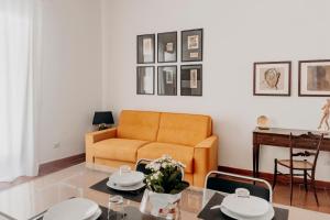 a living room with a couch and a table at New Design Ortigia in Syracuse