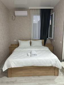 a large white bed with two towels on it at PANORAMA TSALKA პანორამა წალკა in Tsalka