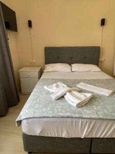 a bedroom with a bed with two towels on it at Almina Kantarcı Pansiyon in Ayvalık +11 photos