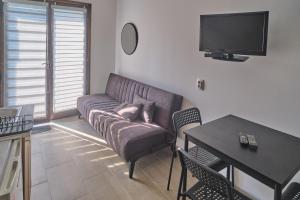 a living room with a couch and a table at Studio Melem 2 in Soko Banja