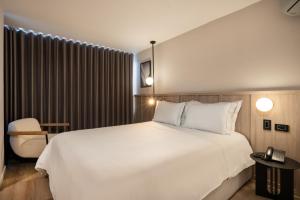 Postel nebo postele na pokoji v ubytování Hotel Egina Medellin