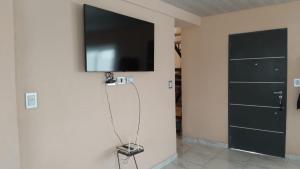a flat screen tv on a wall in a room at El descanso in Gardey