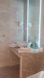 a bathroom with a sink and a counter with towels at SmallHotel - Vevi in Vévi +71 photos