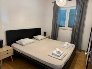 a bedroom with a bed with two towels on it at Apartment Aurea in Makarska