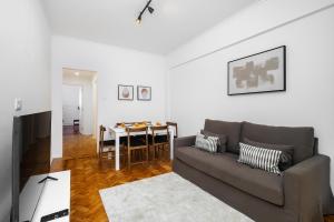 a living room with a couch and a table at WHome Peaceful Algés Family Home away from City Noise in Algés