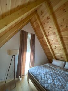 a bedroom with a bed and a window at Žabljak- FamilyOasis in Žabljak +13 photos