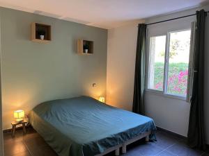 a bedroom with a bed and a window at Bel appart - 3 ch Vallon pont d 'arc in Salavas