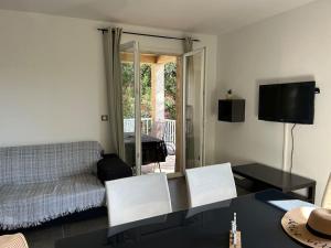 a living room with a couch and a table at Bel appart - 3 ch Vallon pont d 'arc in Salavas