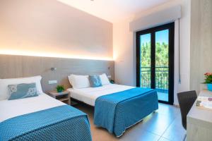 Postel nebo postele na pokoji v ubytování Hotel Altamarea