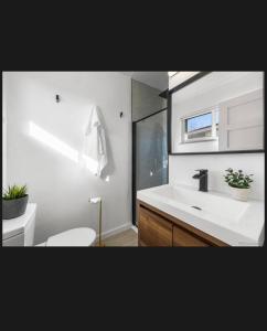 a bathroom with a white sink and a toilet at 4 bedroom 5 beds family house in Denver