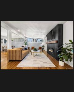 a living room with a couch and a table at 4 bedroom 5 beds family house in Denver