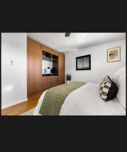 a bedroom with a large bed and wooden cabinets at 4 bedroom 5 beds family house in Denver