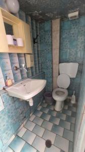a bathroom with a toilet and a sink at Old town Room With Window in Rethymno