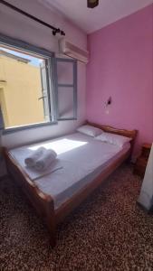 a bedroom with a large bed with a window at Old town Room With Window in Rethymno